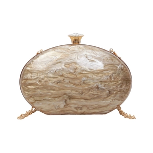 Oval acrylic clutch bag with marble pattern, gold metal chain, and rhinestone clasp