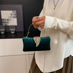 Elegant emerald green velvet evening clutch bag with ornate gold leaf buckle and ring handle