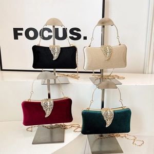 Elegant velvet evening clutch bags with gold leaf clasps in four luxury colors