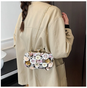 Detail of 3D handmade floral evening bag with metal chain and gemstone clasp closure