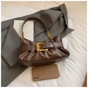 Detail of dark brown pleated leather tote with gold buckle and chunky chain strap