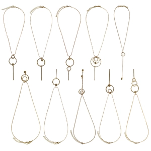 Minimalist gold geometric necklaces with circular and bar pendants on white background