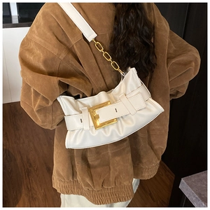 Detail view of white ruched cloud bag with gold buckle and chain shoulder strap