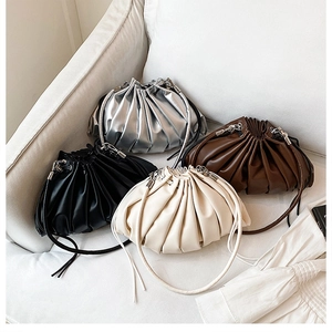 Detailed display of pleated cloud bucket bags in silver, black, brown and beige colors