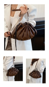 Detail of dark brown pleated cloud bucket bag featuring sleek PU leather and silver hardware
