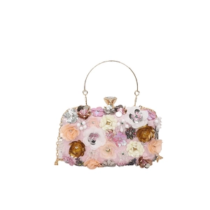 Pink evening bag with floral sequins, beaded petals, and golden metal handle for women