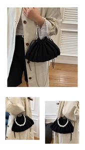 Détail du sac seau plissé noir avec poignée en perles élégante et fermeture à cordon