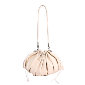 Minimalist beige dumpling bag with pleats and silver hardware for crossbody use