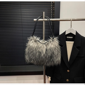 Close-up of fluffy grey faux fur shoulder bag with leather strap on a decorative hanger