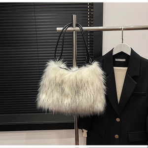 Detail of white faux fur shoulder bag texture with slim black leather strap