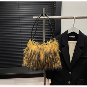 Detail of faux fur shoulder bag featuring yellow and black tiger stripes and thin straps