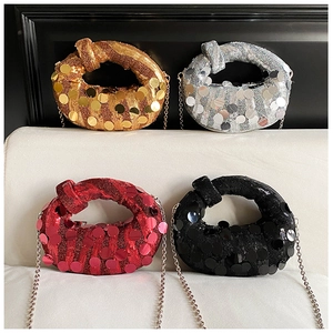 Detail of sequin evening bags with metal chains in gold, silver, red, and black colors