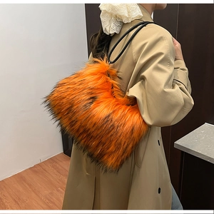 Detail of fluffy orange and black faux fur shoulder bag on a trench coat model