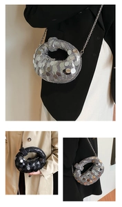 Detail of silver and black sequin crescent bags with reflective metal chain straps