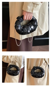 Detail showing shimmering black sequins on the knot handbag with silver metal chain