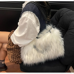 Détail de la texture d'un sac à bandoulière en fausse fourrure blanche sur mannequin
