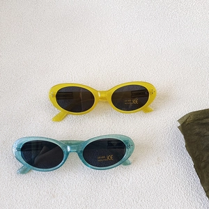 Kids UV400 sunglasses with glitter oval frames in yellow and teal translucent colors