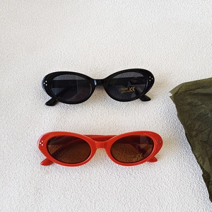 Retro oval kids sunglasses with UV400 protection in classic black and red frames