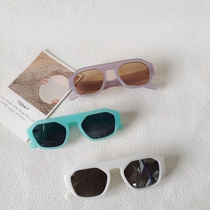 Three pairs of retro oversized geometric sunglasses in lilac, mint, and white frames