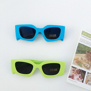 Detail of geometric kid sunglasses with UV400 protection and thick colorful frames
