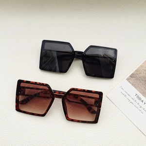 Modern oversized square sunglasses in black and tortoiseshell with UV protection