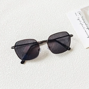 Close-up of kids square metal sunglasses with dark lenses and adjustable nose pads