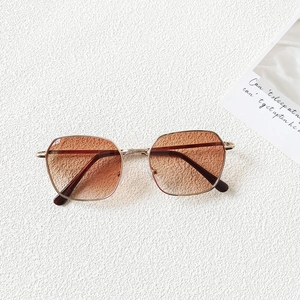Detailed top view of gold frame geometric sunglasses with light brown gradient lenses