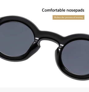 Detail of comfortable integrated nose pads on black round frame sunglasses for reduced pressure