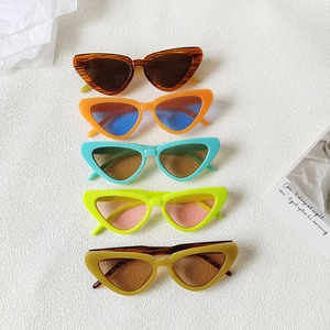 Five pairs of trendy cat-eye sunglasses with colorful lenses and vibrant frames