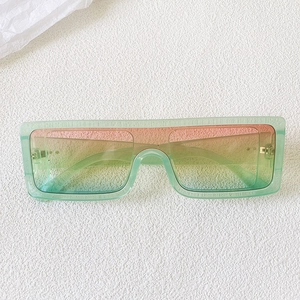 Macro view of mint green square sunglasses with colorful tri-color gradient lenses