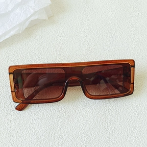 Close-up of vintage oversized orange rectangle sunglasses with brown tinted lenses