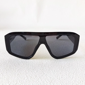 Close-up of the glossy black frame and one-piece smoke gray lens of these shield sunglasses