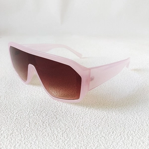 Detail of light pink oversized wrap-around sunglasses with brown gradient lenses
