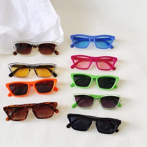 Flat lay of retro square sunglasses in multiple vibrant candy colors and leopard patterns