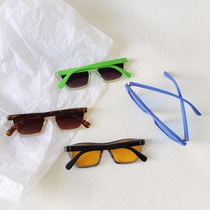 Retro cat-eye sunglasses set in candy colors with square frames and signature dot detail