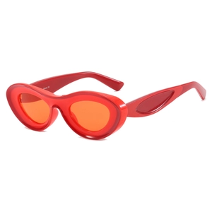 Chic 2025 oval sunglasses with chunky red frames and translucent orange lenses