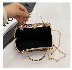 Close-up of evening clutch showing black velvet lining and spacious interior storage