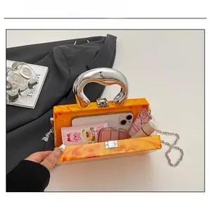 Interior view showing the storage capacity of the orange marble acrylic clutch bag
