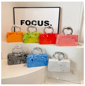 Detailed macro view of colorful marble texture acrylic evening bags with silver handles