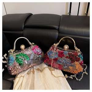 Detailed view of sequined evening clutch bags with floral patterns and pearl clasps