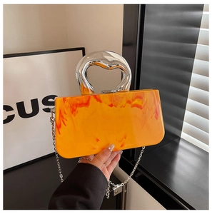 Detail of orange marble texture bag with silver irregular handle and chain strap