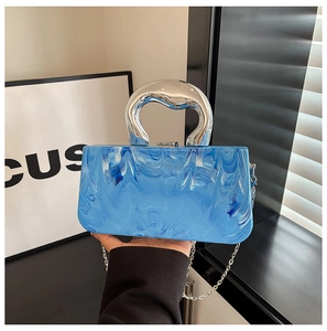 Detail of blue marble resin box bag with artistic silver metal handle and chain strap