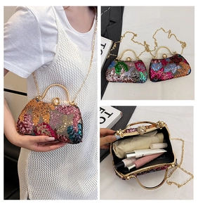 Detail of colorful sequin clutch with gold metal handle and pearl clasp with inner storage