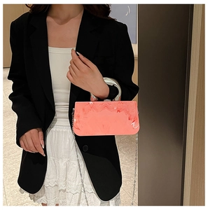 Pink marble acrylic evening bag with gold circular handle and metal chain shoulder strap