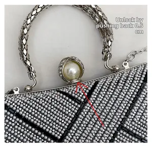 Detail of evening clutch with pearl clasp mechanism and sparkling rhinestone texture