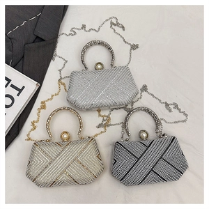 Detail of rhinestone evening bags with pearl clasps and woven handles in three colors