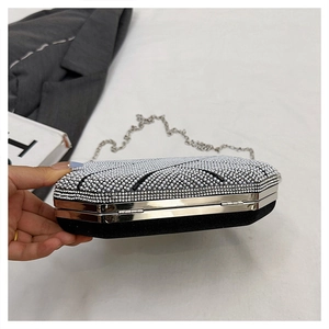 Macro view of octagonal evening clutch bag with black base and shimmering silver rhinestones