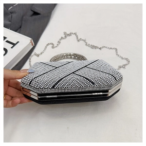 Macro shot of silver rhinestone evening clutch showing cross-line texture and metal frame