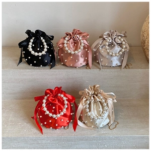 Multi-color satin drawstring bucket bags featuring pearl embellishments and top handles
