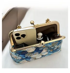 Detail view of butterfly embroidery bag with space for smartphone and cosmetics